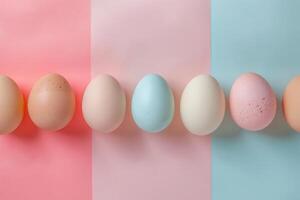 AI generated Top view pastel Easter eggs on pink background with Copy space. Holiday banner with colorful chicken eggshells photo