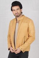 studio shot of young handsome indian man wearing brown leather jacket against white background photo