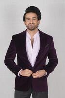 young handsome man in suit posing in studio photo