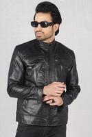 full - length portrait of young man in leather jacket and sunglasses posing in studio photo