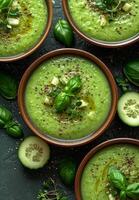 AI generated Green soup puree with cucumber avocado spinach and herbs in bowl on dark background. photo