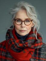 ai generado elegante antiguo mujer con gris pelo y lentes en a cuadros rojo bufanda foto