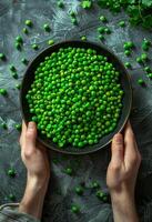 AI generated Green peas in bowl on dark background photo