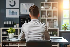 AI generated Rear view of young businessman working on computer in office photo