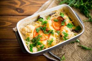 cauliflower baked with chicken fillet and mushrooms under cheese in a ceramic form photo