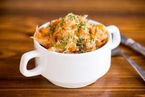 stewed cabbage with carrots and spices in a bowl photo