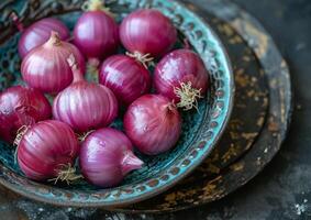 AI generated Red onions in blue bowl on dark background photo