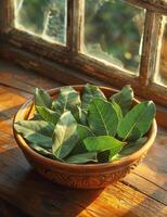 AI generated Bay leaves in bowl on wooden table photo