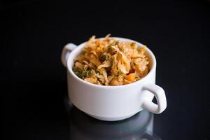 stewed cabbage with carrots and spices in a bowl photo