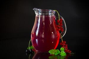 Cold refreshing drink from fresh summer berries in a decanter. photo