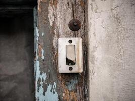 a broken white switch attached to a wall that was also broken photo