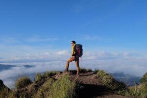 Peak Paradise, Asian Model on Mount Batur Summit with Ocean of Clouds under Azure Sky photo