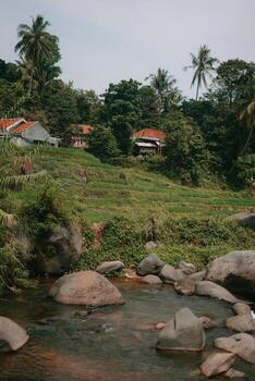Refreshing Curug Sentul Clear River Flowing from Waterfall, Surrounded by Forests, Ideal for Nature Lovers photo