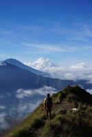 Peak Paradise, Asian Model on Mount Batur Summit with Ocean of Clouds under Azure Sky photo