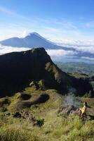 Asian Adventure, Man Model on Mountain Summit, Carrying Hiking Gear under Blue Sky above Ocean of Clouds photo