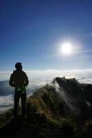 Peak Paradise, Asian Model on Mount Batur Summit with Ocean of Clouds under Azure Sky photo