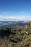 Peak Paradise, Asian Model on Mount Batur Summit with Ocean of Clouds under Azure Sky photo