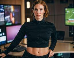 AI generated photo of beautiful woman as a commander agent wearing black long sleeve shirt and tactical pant with monitor and screen in control command room, generative AI