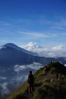 Peak Paradise, Asian Model on Mount Batur Summit with Ocean of Clouds under Azure Sky photo