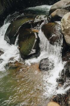Refreshing Curug Sentul Clear River Flowing from Waterfall, Surrounded by Forests, Ideal for Nature Lovers photo