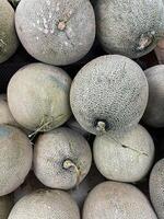 Fresh melons displayed at the fruit market photo