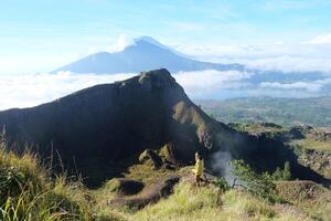 Peak Paradise, Asian Model on Mount Batur Summit with Ocean of Clouds under Azure Sky photo