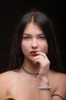 Studio portrait of a young beautiful girl with long hair 1 photo