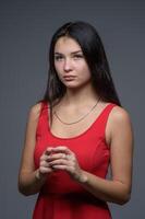 Studio portrait of a young beautiful girl in a red dress 2 photo