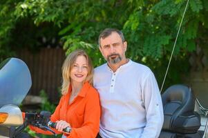 happy husband and wife near a motorcycle 1 photo