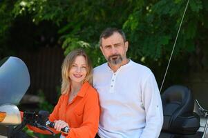 happy husband and wife near a motorcycle 2 photo