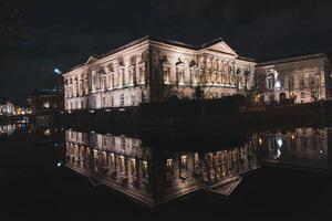 View of an American-style opera house reflected in a water channel in the centre of Ghent, Flanders, Belgium photo