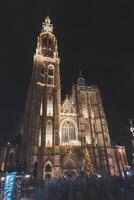 Christmas lights illuminate the cathedral in the historic centre of Antwerp. The beauty of the Christmas market in December in Belgium photo