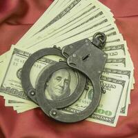 Money and drugs, handcuffs lie on a beautiful background photo