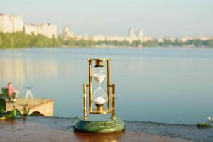 Beautiful hourglass counts time in nature photo