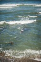 View from above of sea waves pounding on the headland. Atlantic ocean background photo