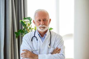 Portrait of senior mature health care professional, doctor, with stethoscope photo