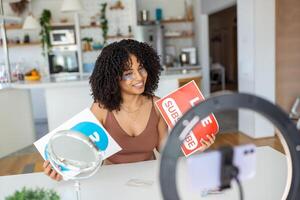 Young female influencer with eye patches using her smart phone for filming a vlog post. photo