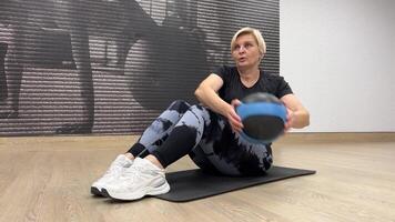 Woman performs abdominal exercises with a fit ball. photo