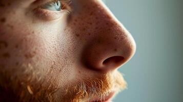 ai generado de cerca retrato de un joven hombre con pecas y rojo barba, con confianza mirando a el cámara foto