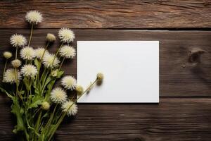 AI generated mockup white blank paper sheet with white fluffy wild flowers top view on wooden background, floral template empty card flat lay for design with copy space photo