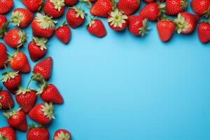 AI generated sweet red ripe strawberry frame on blue background top view, fresh berries template with copy space photo