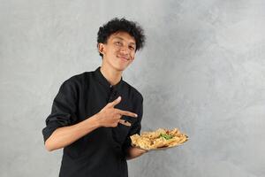 Asian Male Holding Various Gorengan with Green CHilli for Breaking the Fast photo