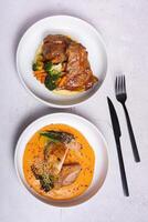 Two plates with meat dishes and mashed potatoes top view, flat lay photo