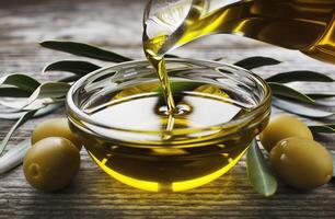 AI generated Pouring Golden Olive Oil into Glass Bowl Amidst Fresh Olives and Leaves photo