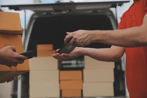 Asian delivery express courier young man use giving boxes to woman customer he wearing protective face mask at front home photo