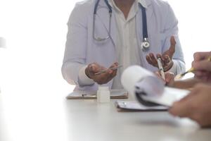 Medical Team Meeting Around Table In Modern Hospital photo