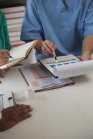 Medical Team Meeting Around Table In Modern Hospital photo