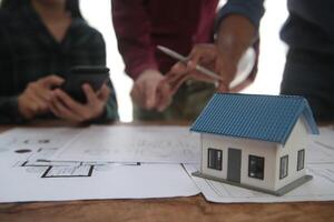 Diverse Team of Specialists Use Laptop on Construction Site. Real Estate Building Project with Engineer Investor and Businessman Checking Area, working on Civil Engineering, Discussing Strategy Plan photo