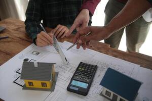 Diverse Team of Specialists Use Laptop on Construction Site. Real Estate Building Project with Engineer Investor and Businessman Checking Area, working on Civil Engineering, Discussing Strategy Plan photo