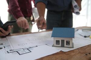 Diverse Team of Specialists Use Laptop on Construction Site. Real Estate Building Project with Engineer Investor and Businessman Checking Area, working on Civil Engineering, Discussing Strategy Plan photo